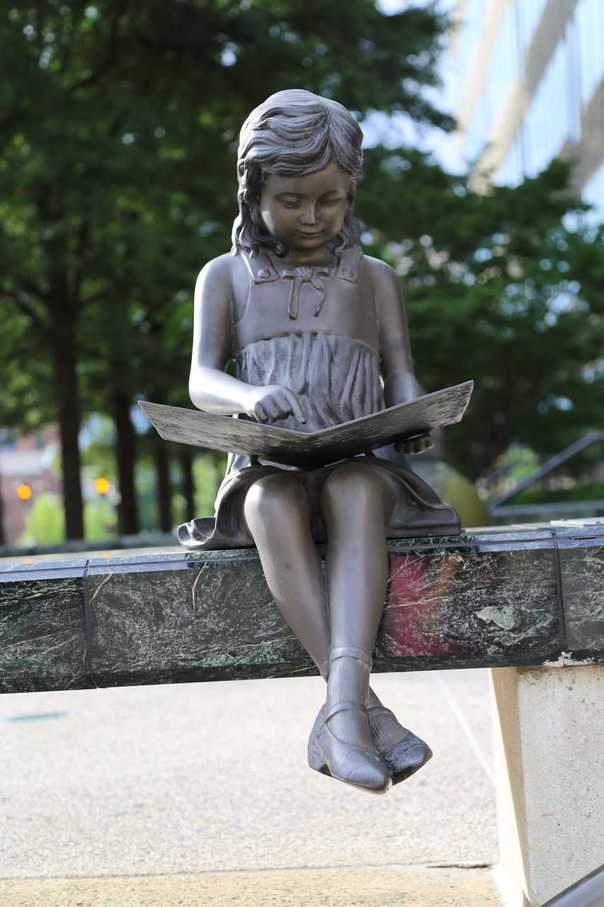 girl reading statue free photo