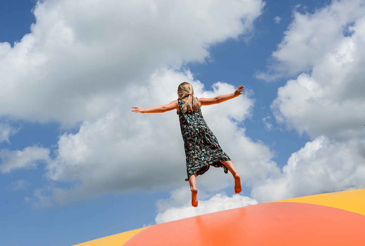 girl jumping pillow free photo