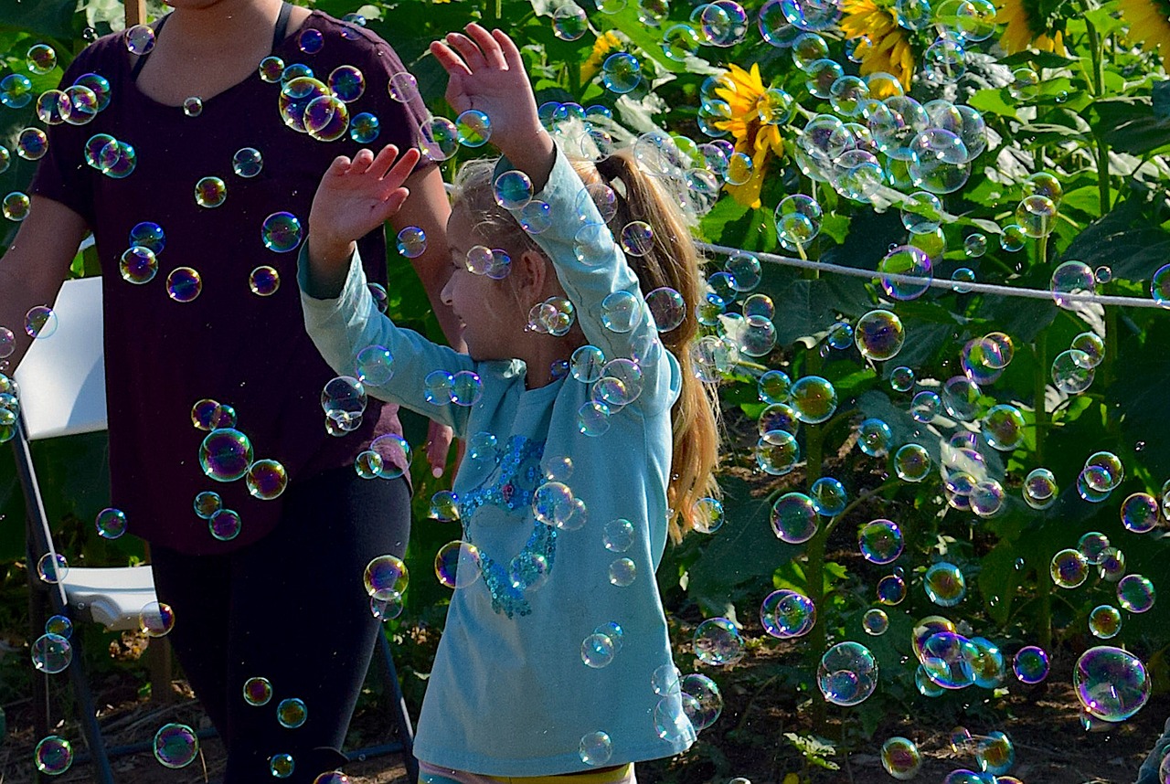 girl playing bubbles free photo