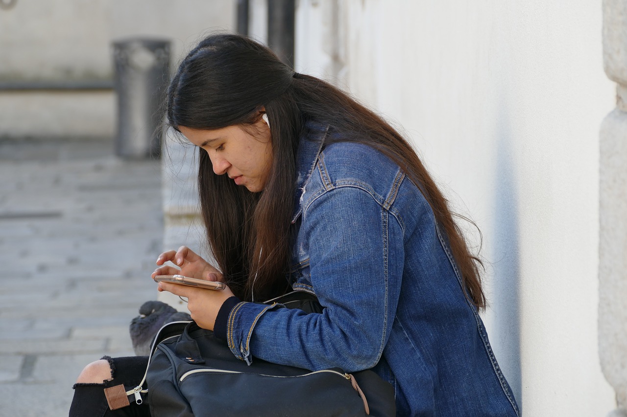 girl  phone  street photography free photo