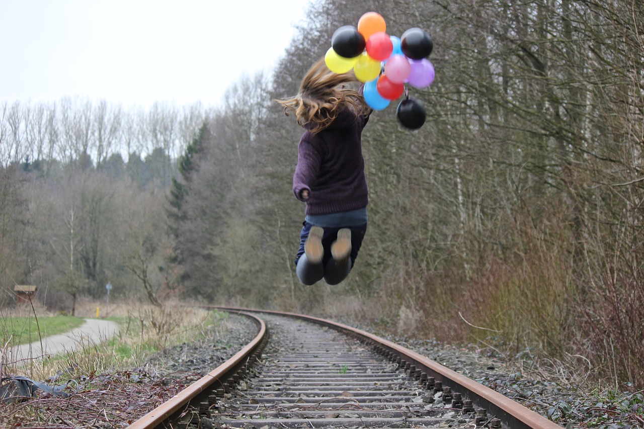 girl railway rails balloons free photo