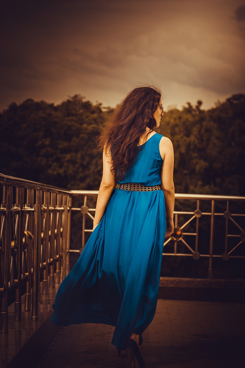 girl in a long dress from the back blue hands free photo