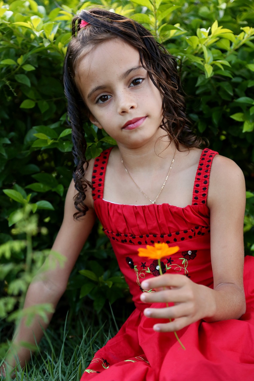 girl looking holding flower girl in the garden free photo