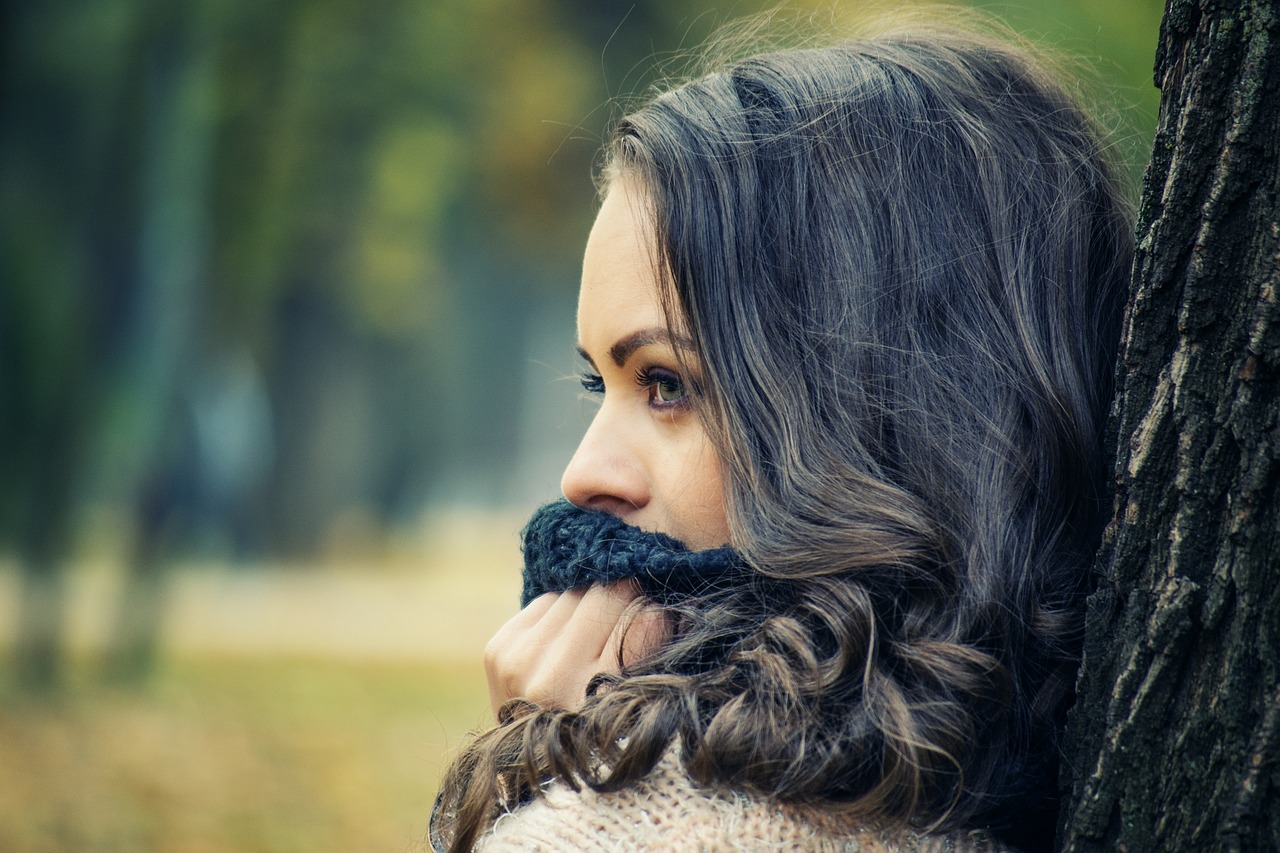 girl looking away girls with scarf on her mouth girl portrait outdoors free photo