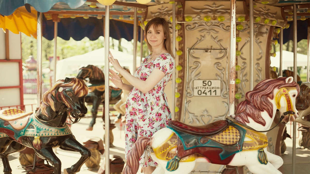 girl on carousel horse pregnant free photo