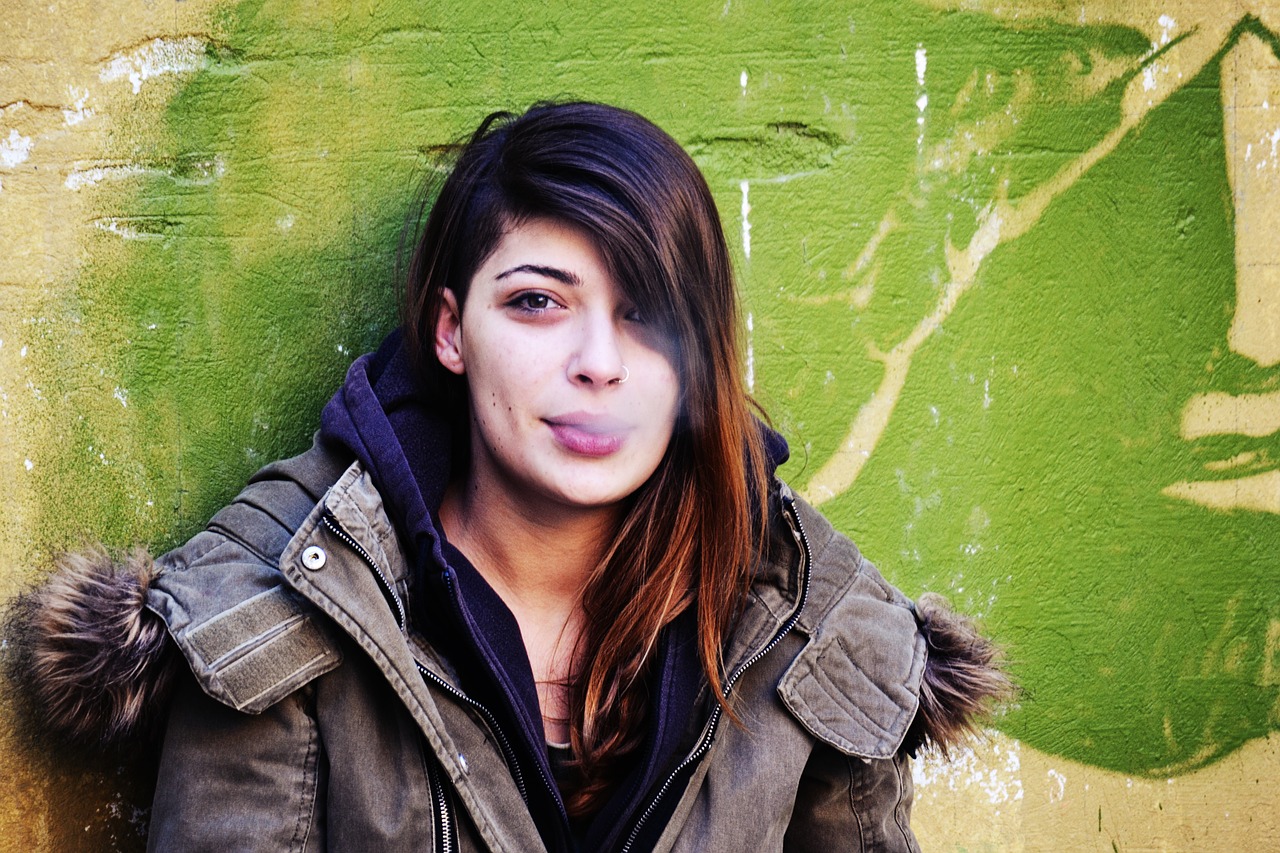 girl smoking leaning on the wall girl portrait colorful outdoor scene free photo