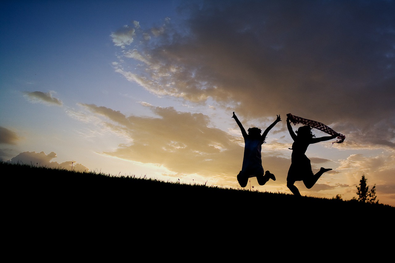 girls jumping sunset free photo