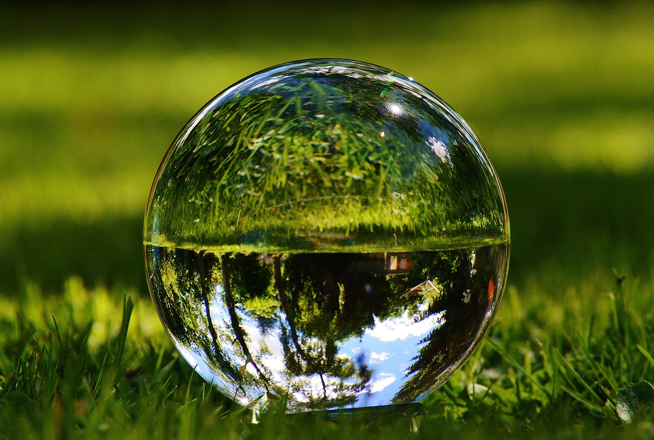 glass ball mirroring meadow free photo