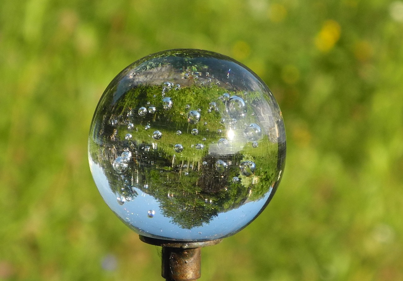 glass ball mirroring topsy-turvy world free photo