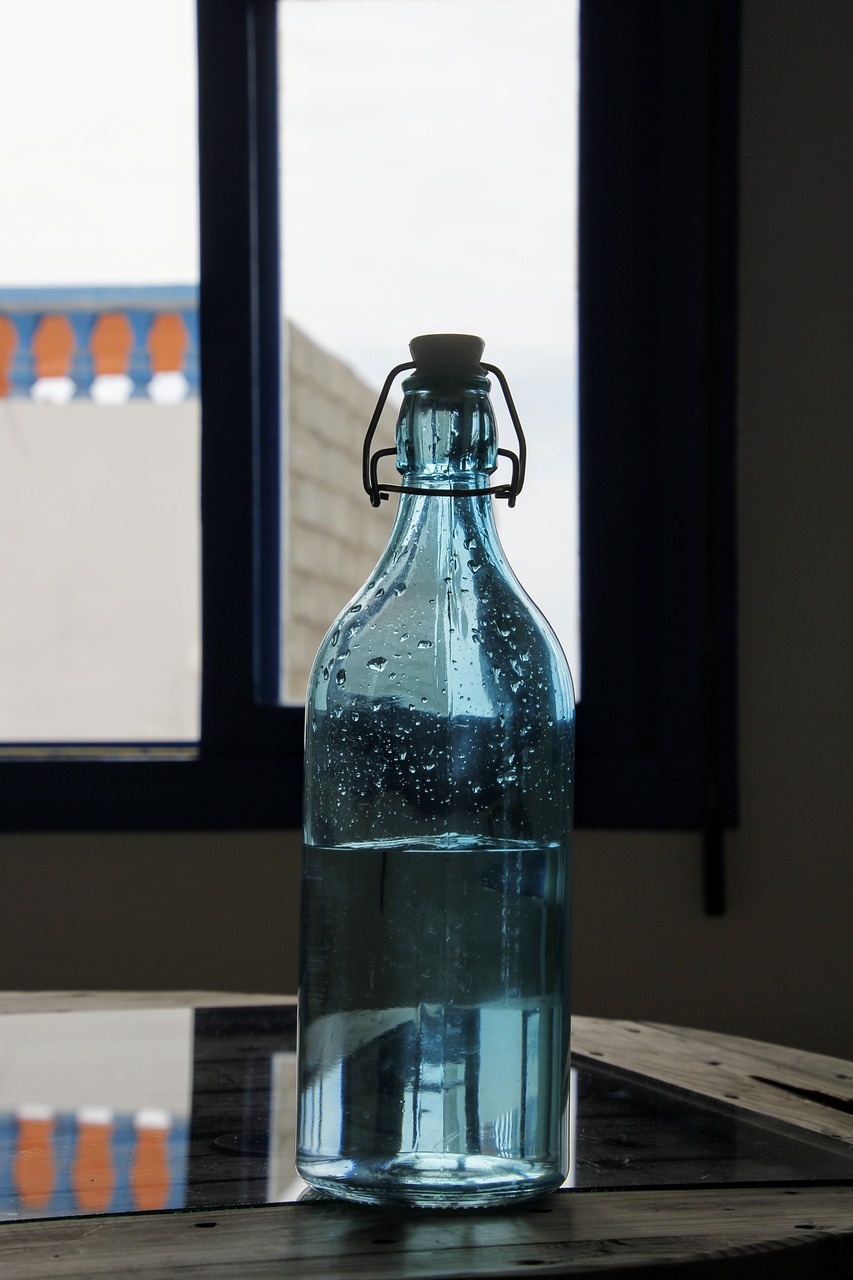 glass bottle blue water free photo