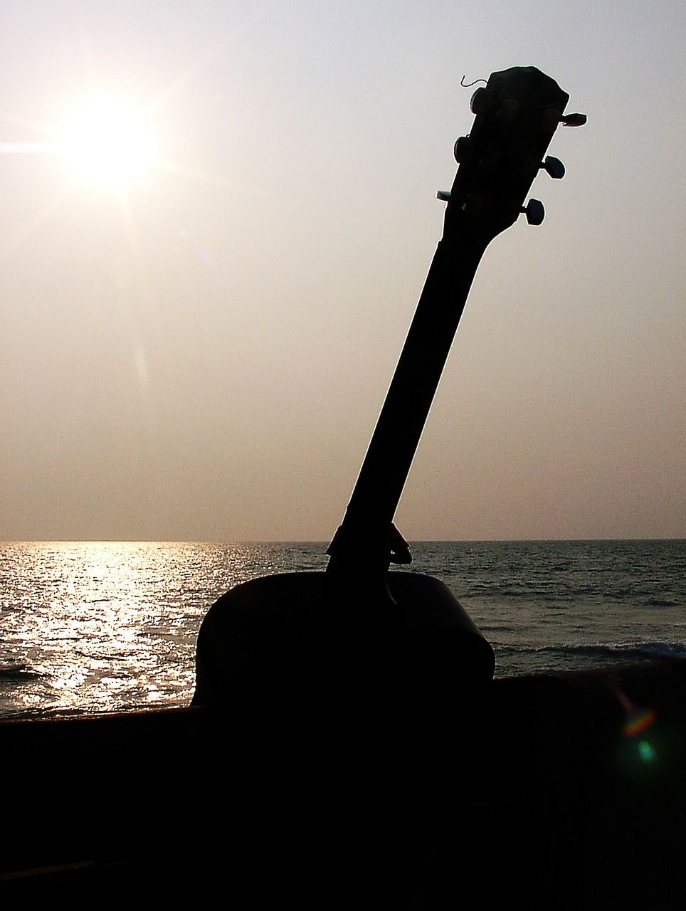 guitar sun set guitar on bench free photo