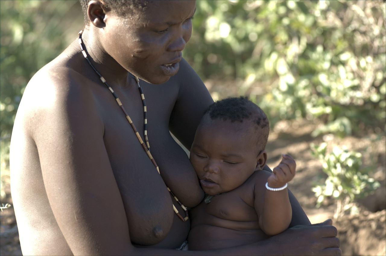 hadzabe brat full at the in his mother's lap free photo