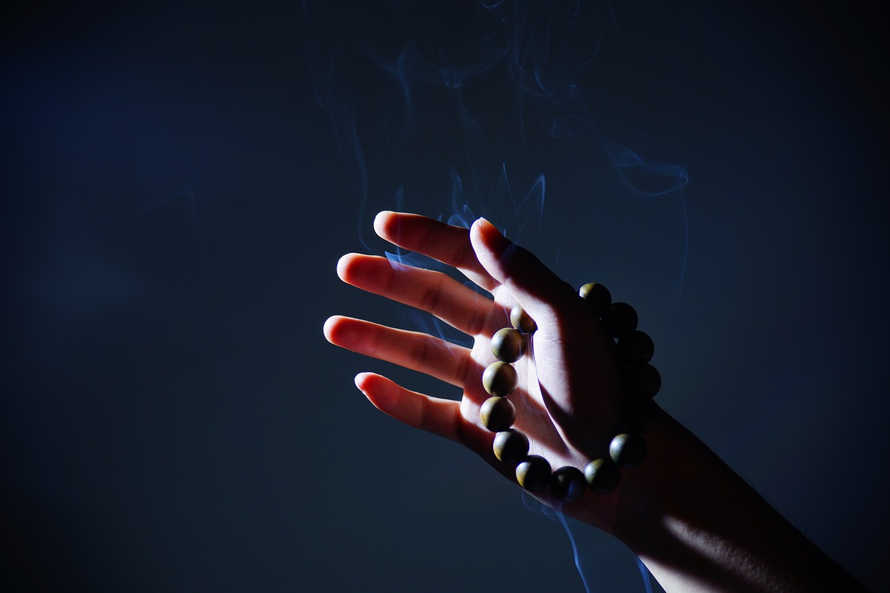 hand buddhist prayer beads smoke free photo