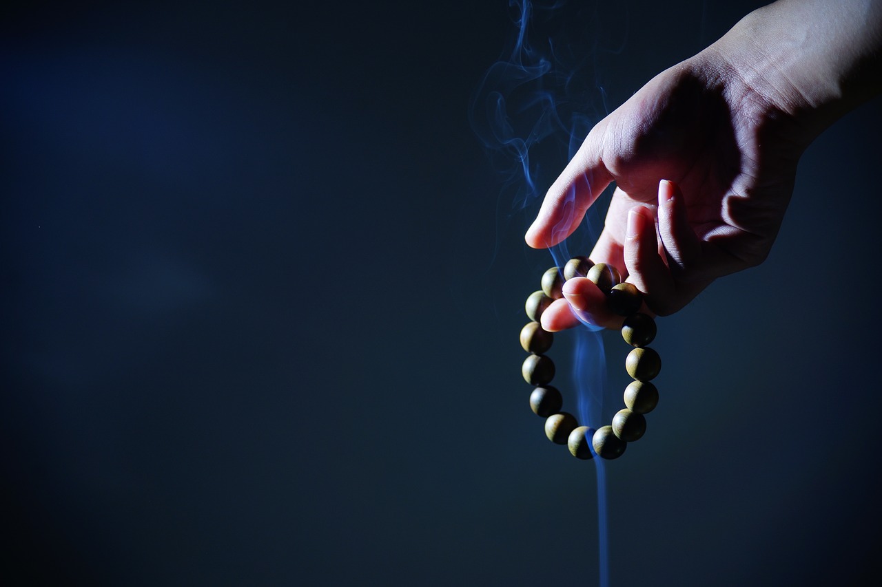 hand buddhist prayer beads smoke free photo