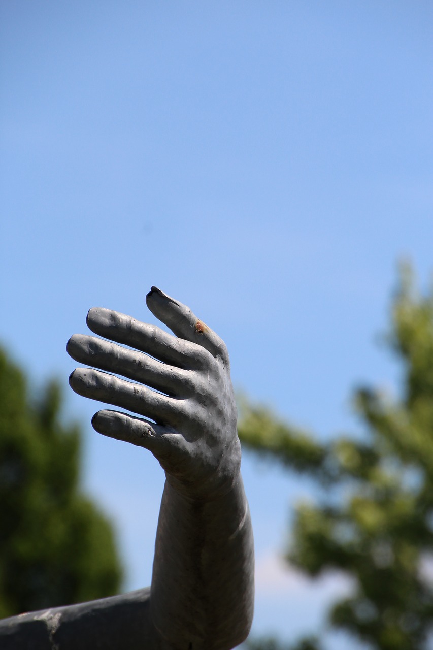 hand metal sculpture free photo