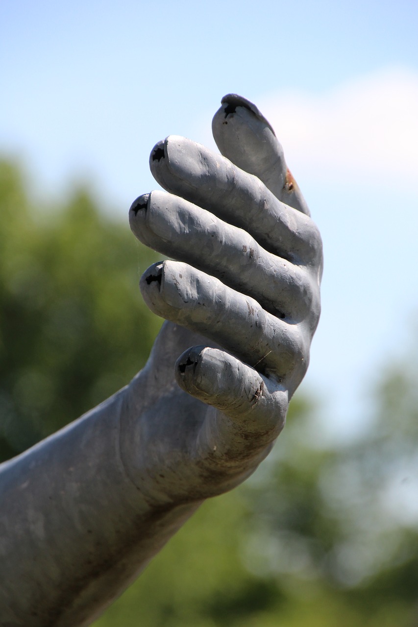 hand metal sculpture free photo