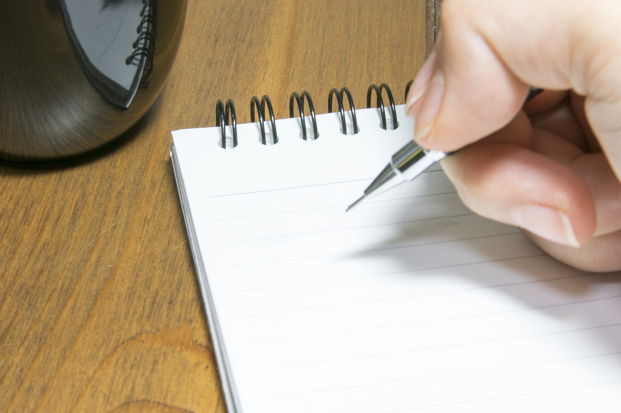 hand and pen writing white laptop free photo