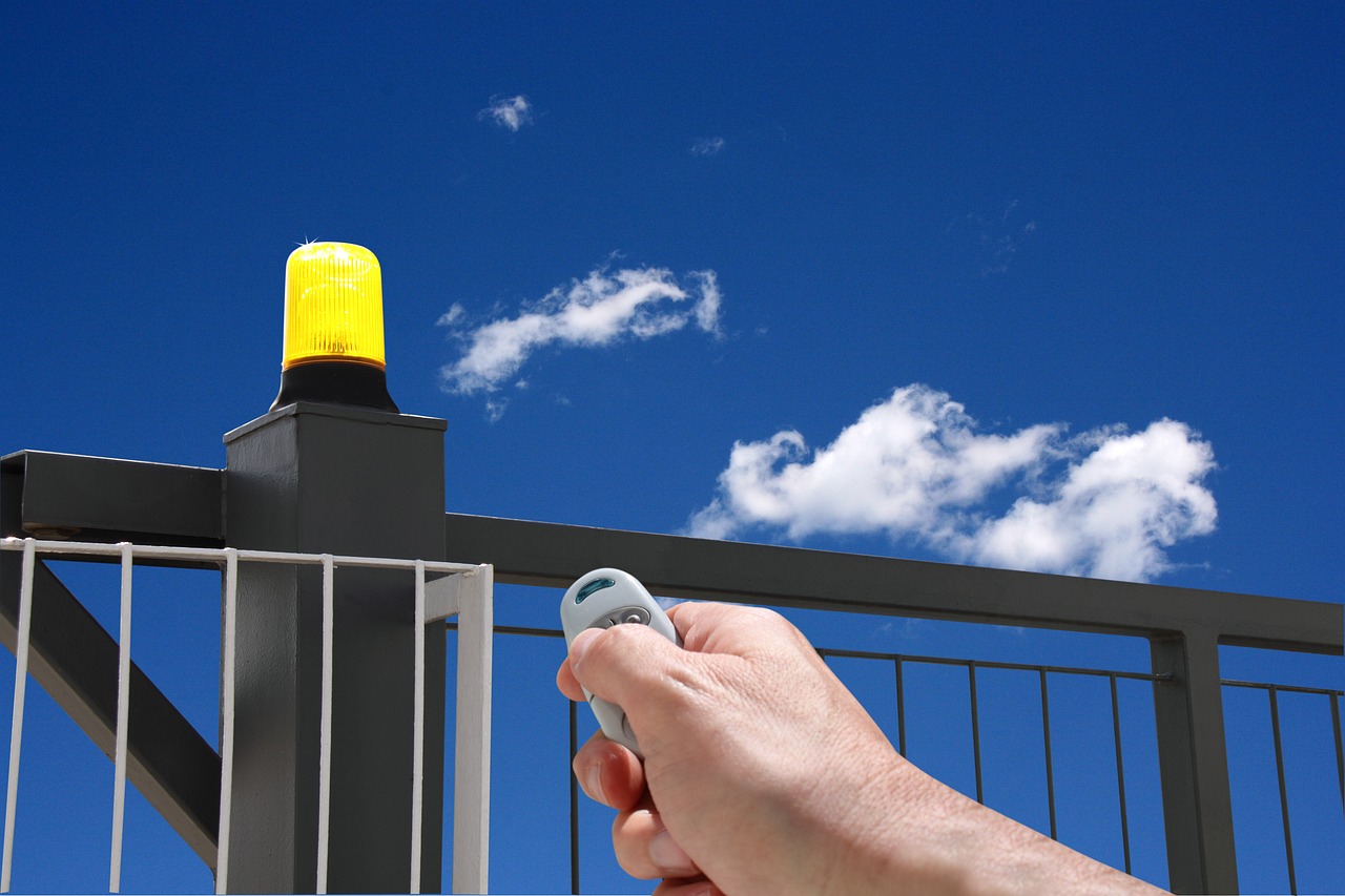 hand with remote control automatic gate gate opening free photo