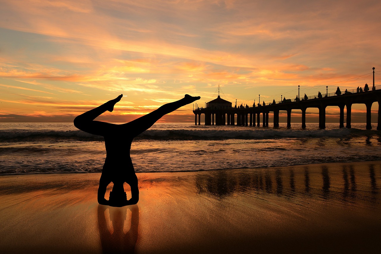 headstand yoga on the beach sunset beach free photo