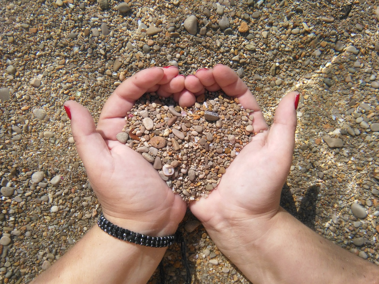 heart pebbles hands free photo