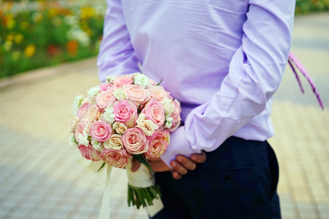 holding flowers the groom location free photo