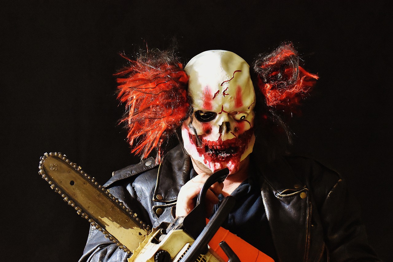 horror clown mass murderer chainsaw free photo