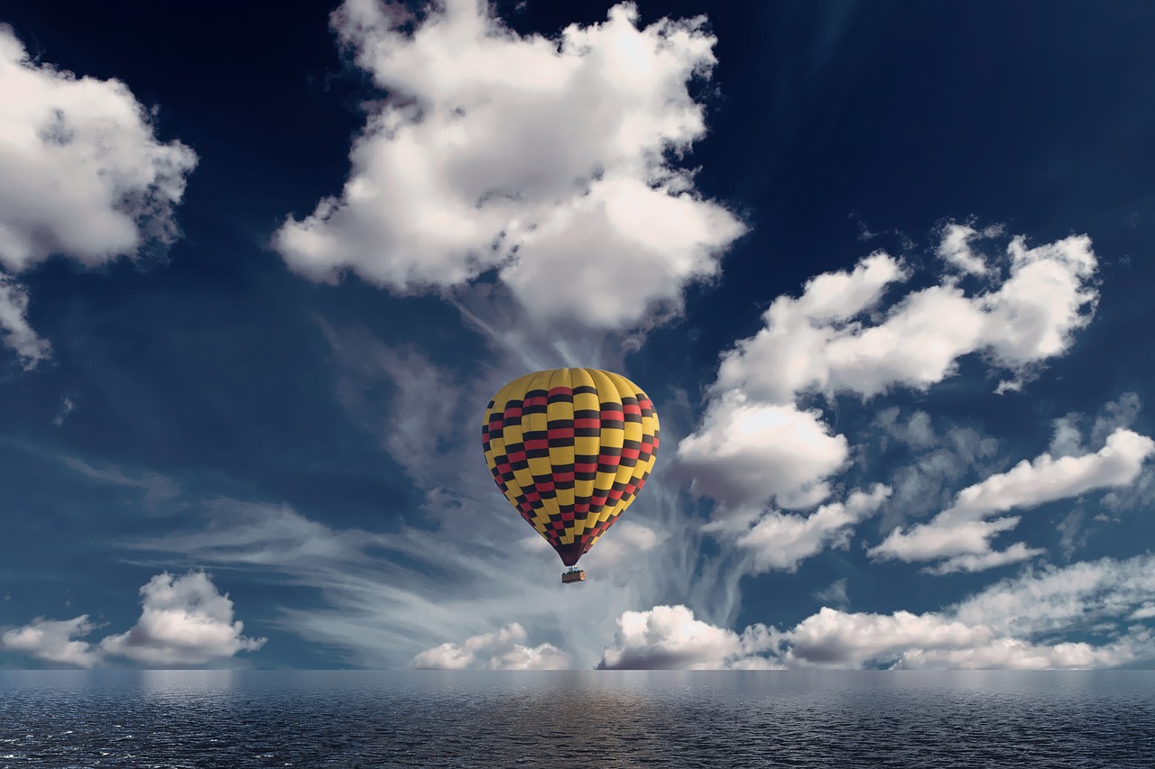 hot air balloon  clouds  reflection free photo
