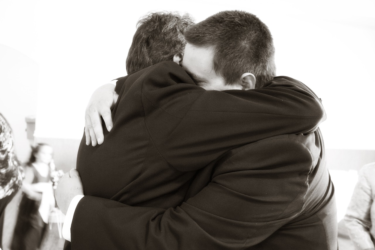 father and son hugging crying