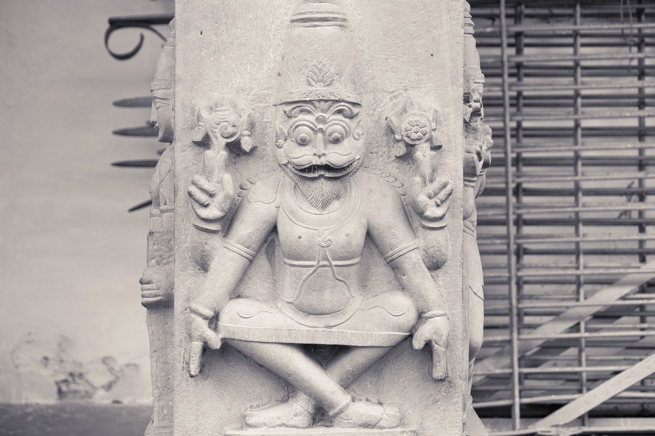 indian statue on the column vrindavan rock free photo