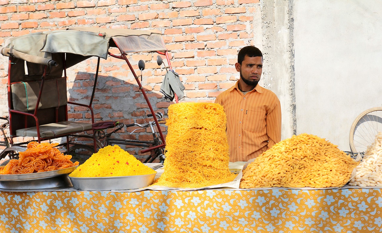 indian street vendor selling sweets free photo