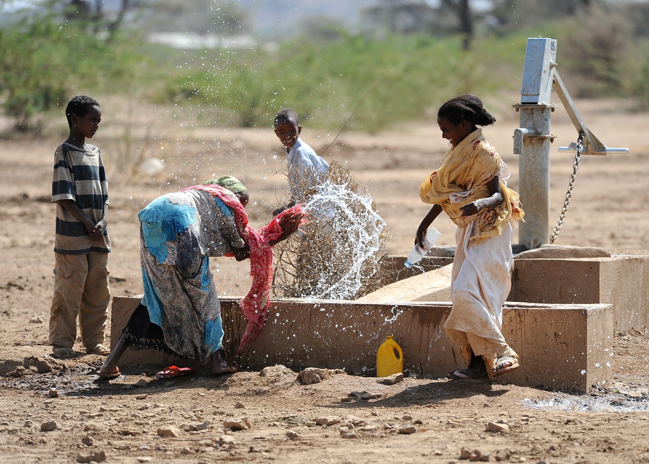 African Children Playing At The Village Water Pump Stock Photo