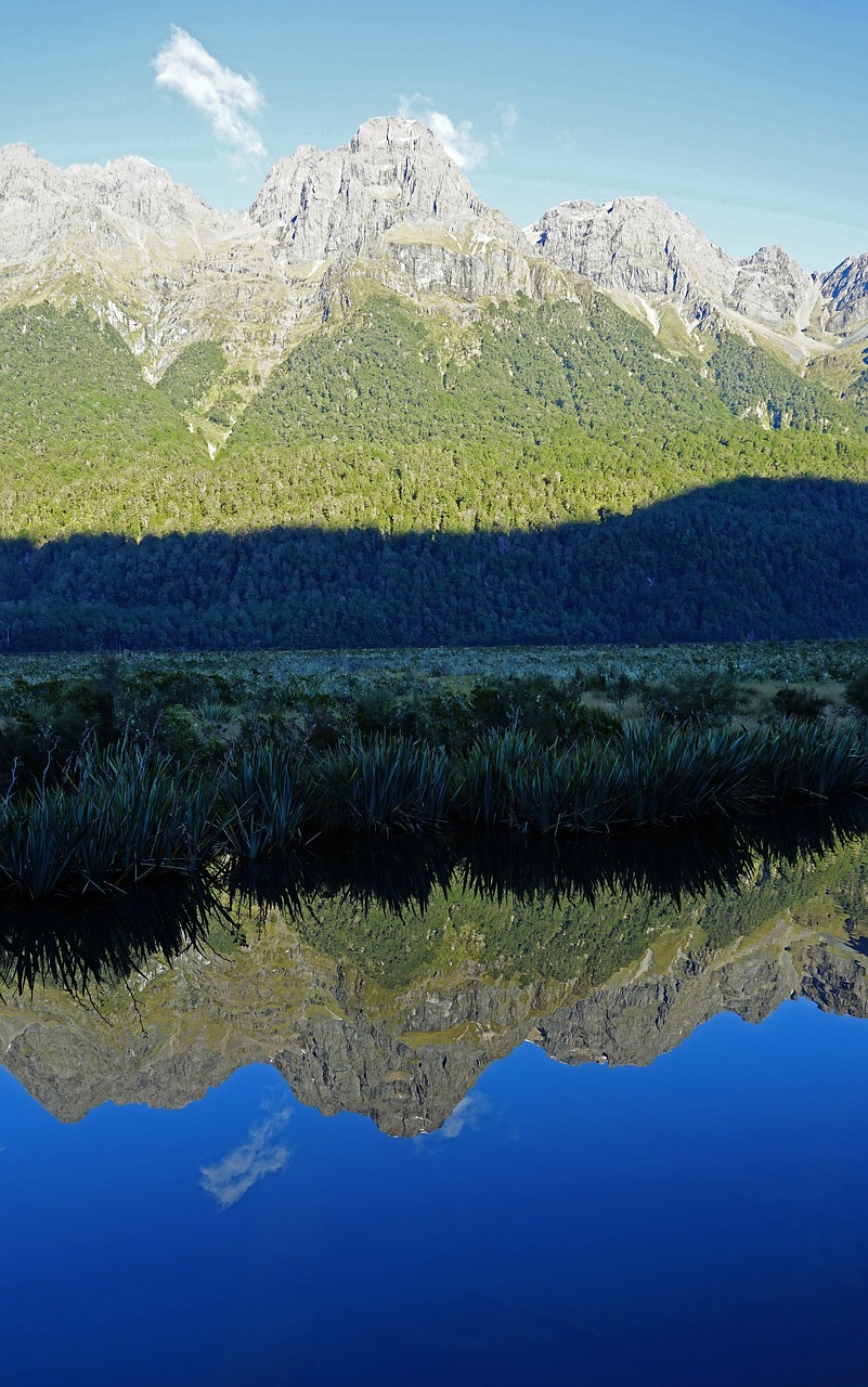 lake mirroring mountains free photo