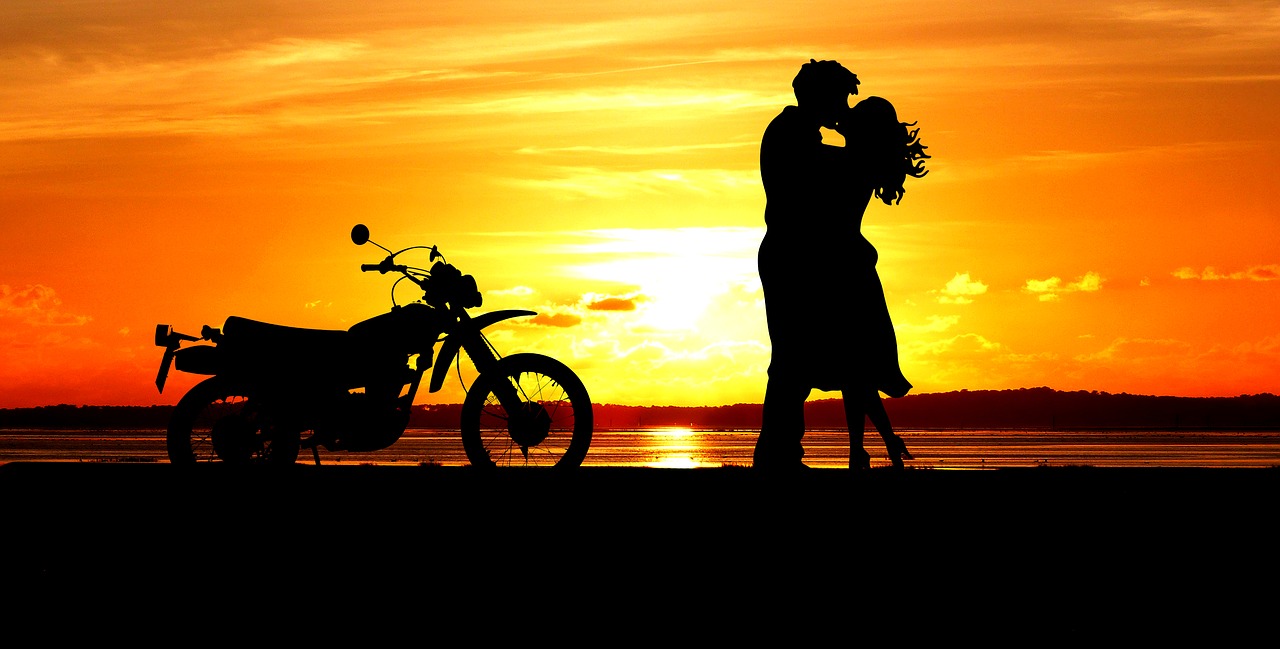 layer of the sun  couple  motorcycle free photo