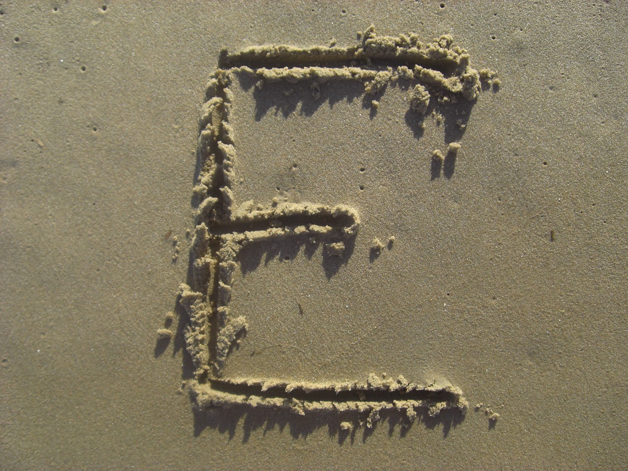 letter e sand stick free photo