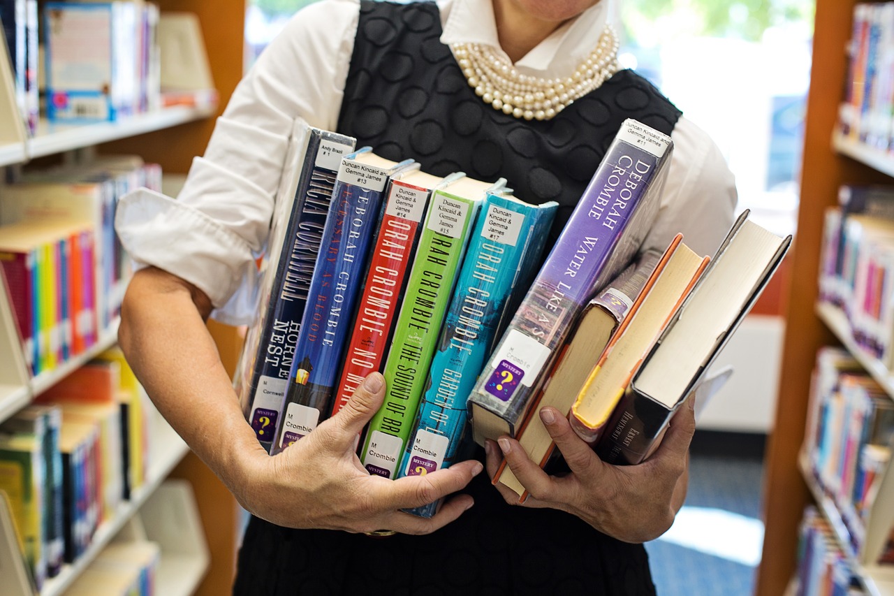 library  books  woman holding books free photo