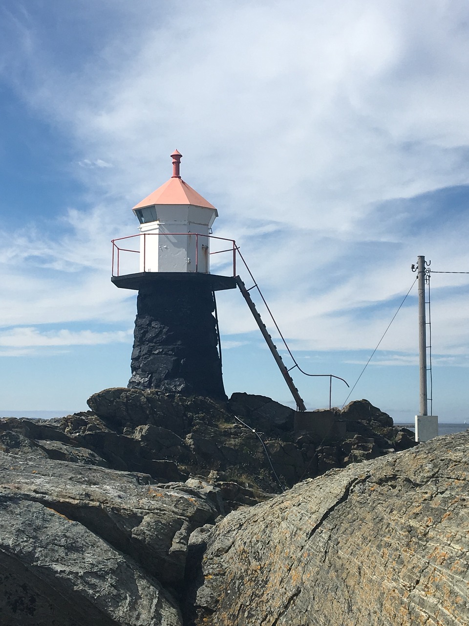 lighthouse blue rocks free photo