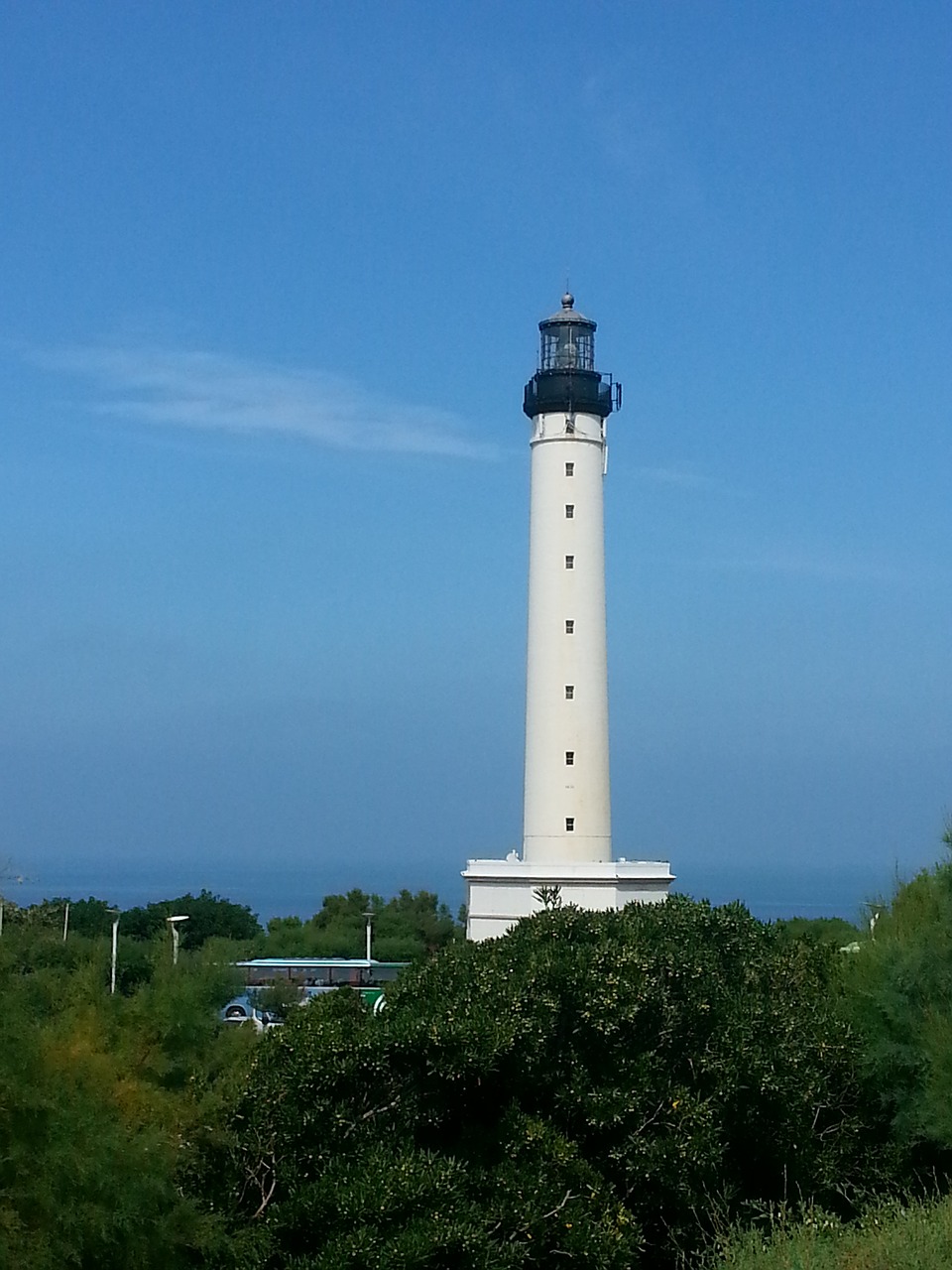 lighthouse blue sky side free photo