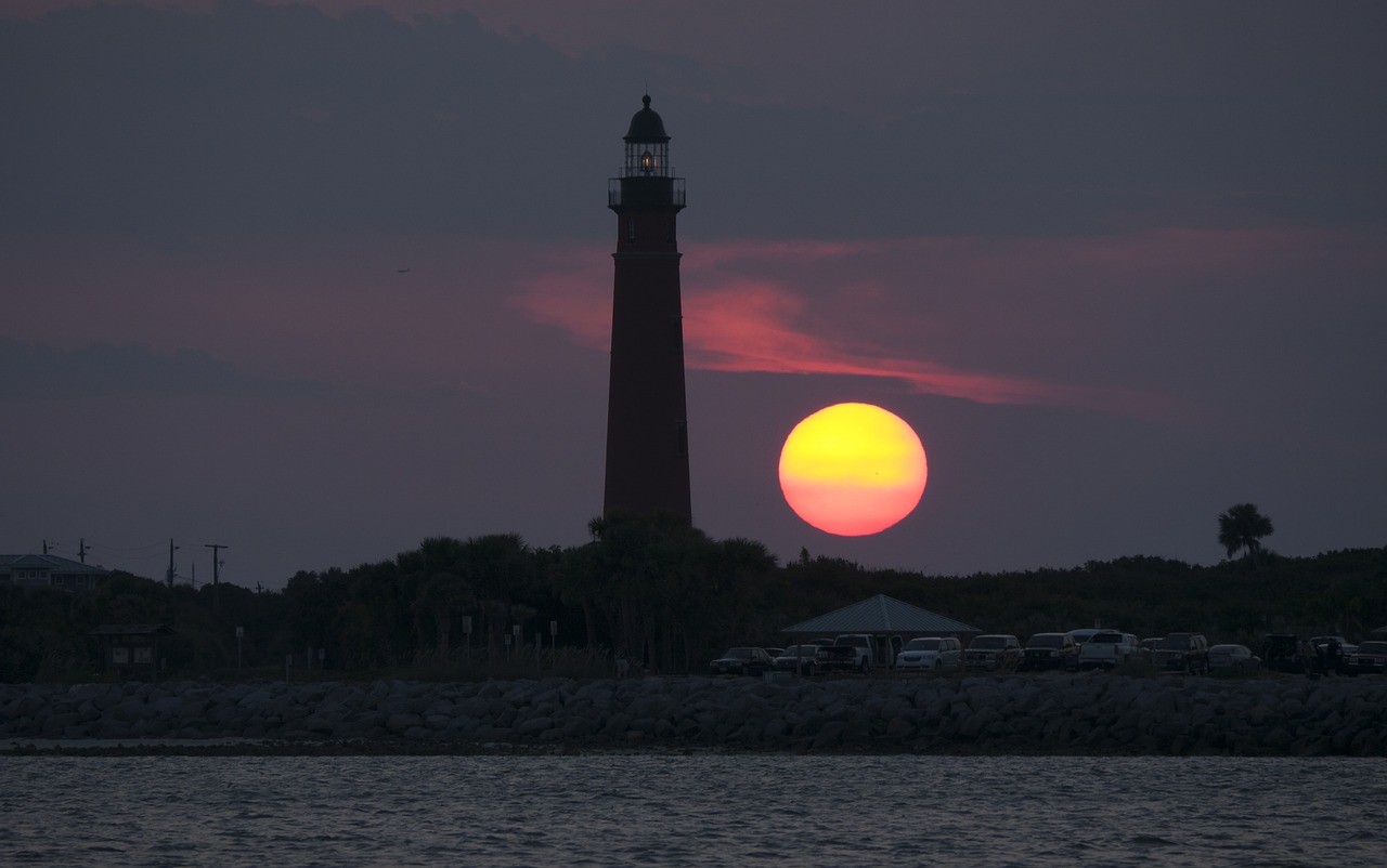 lighthouse sunset sea free photo