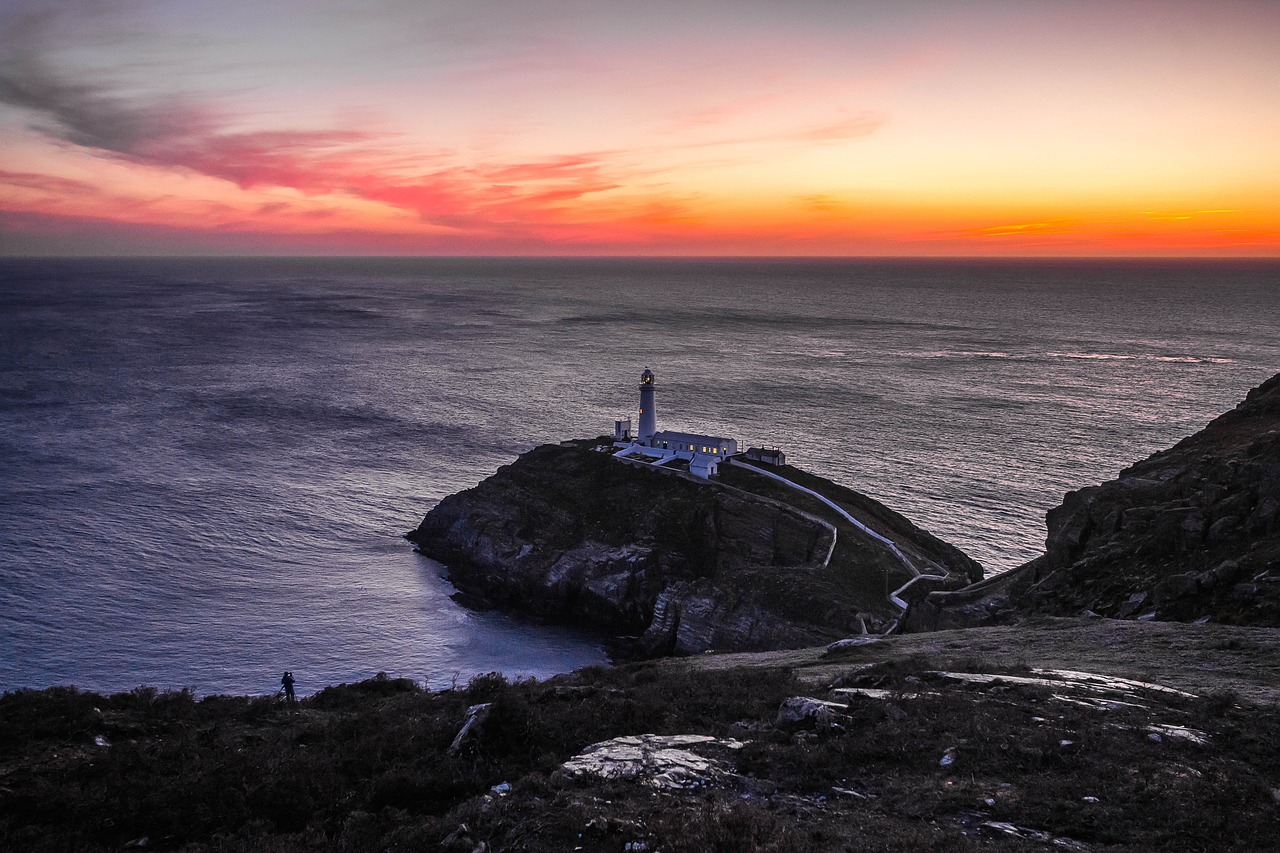 lighthouse ocean in the evening free photo