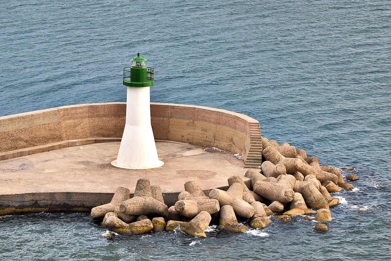 lighthouse white green sea free photo