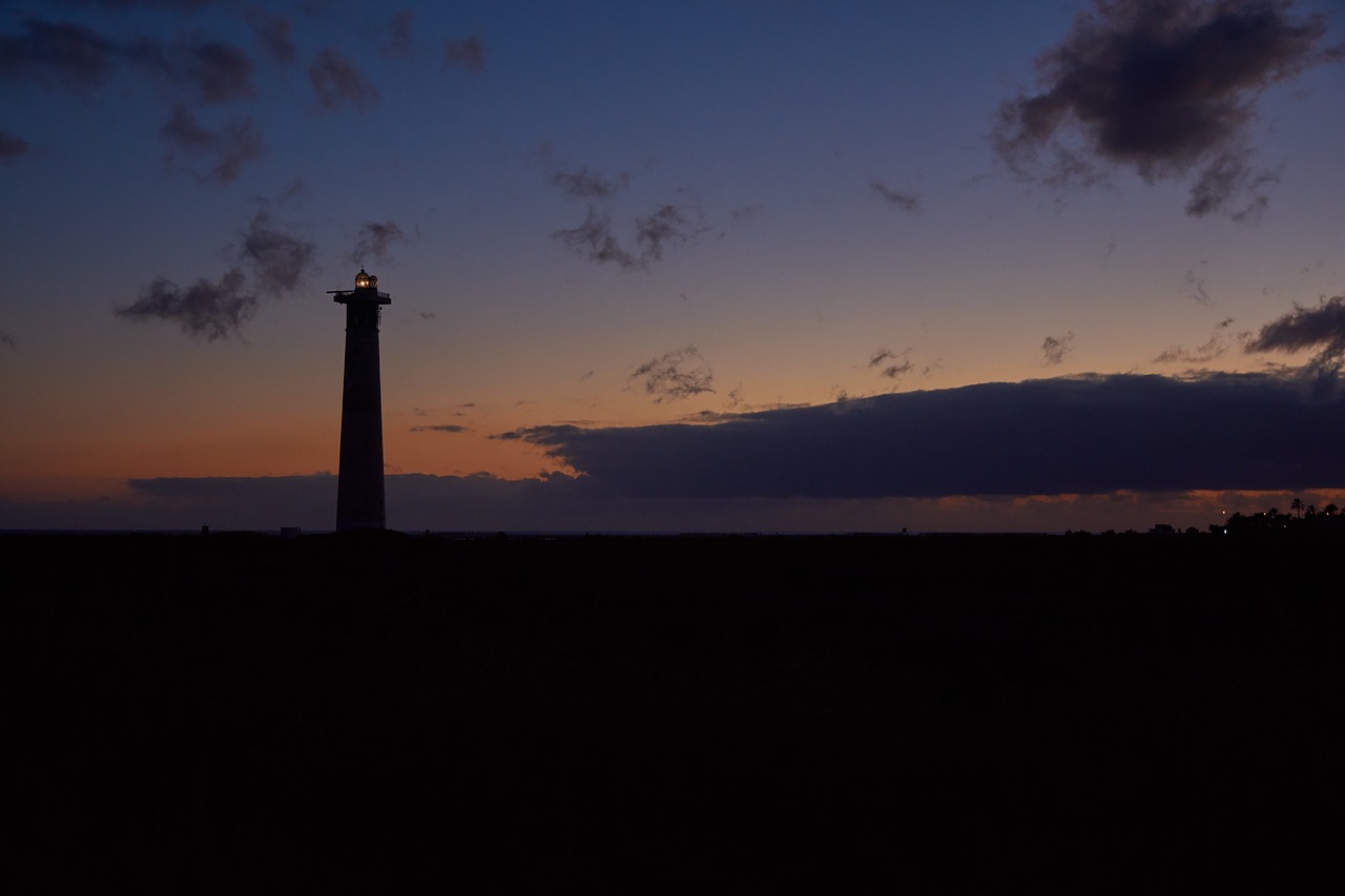 lighthouse evening sky beach free photo