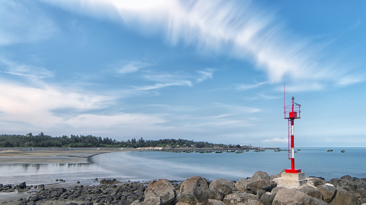 lighthouse  beach  blue sky free photo