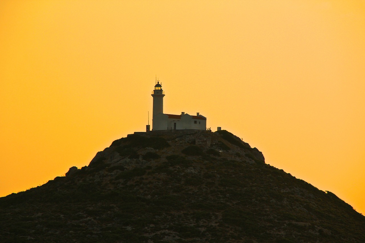 lighthouse yellow sky sunset free photo