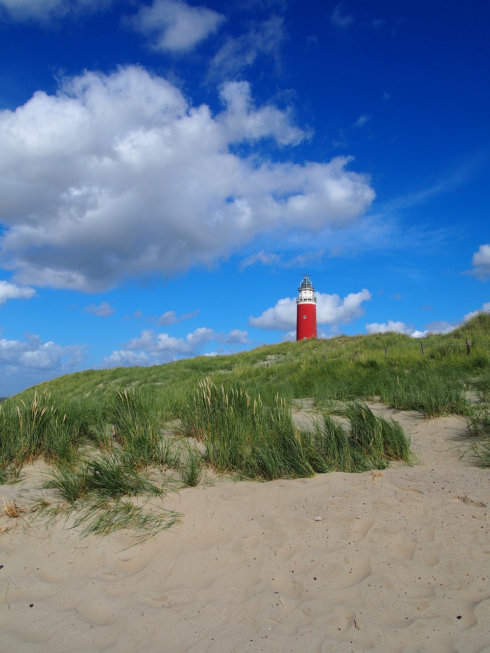 lighthouse beach clouds free photo