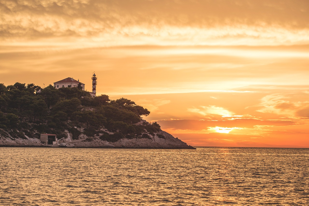 lighthouse sunset sea free photo