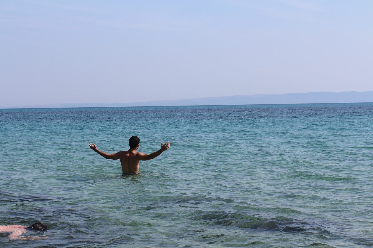 hands up swimming sea free photo