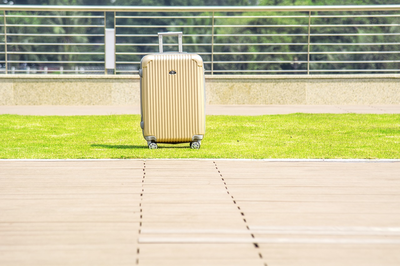 luggage on wheels case outdoors free photo