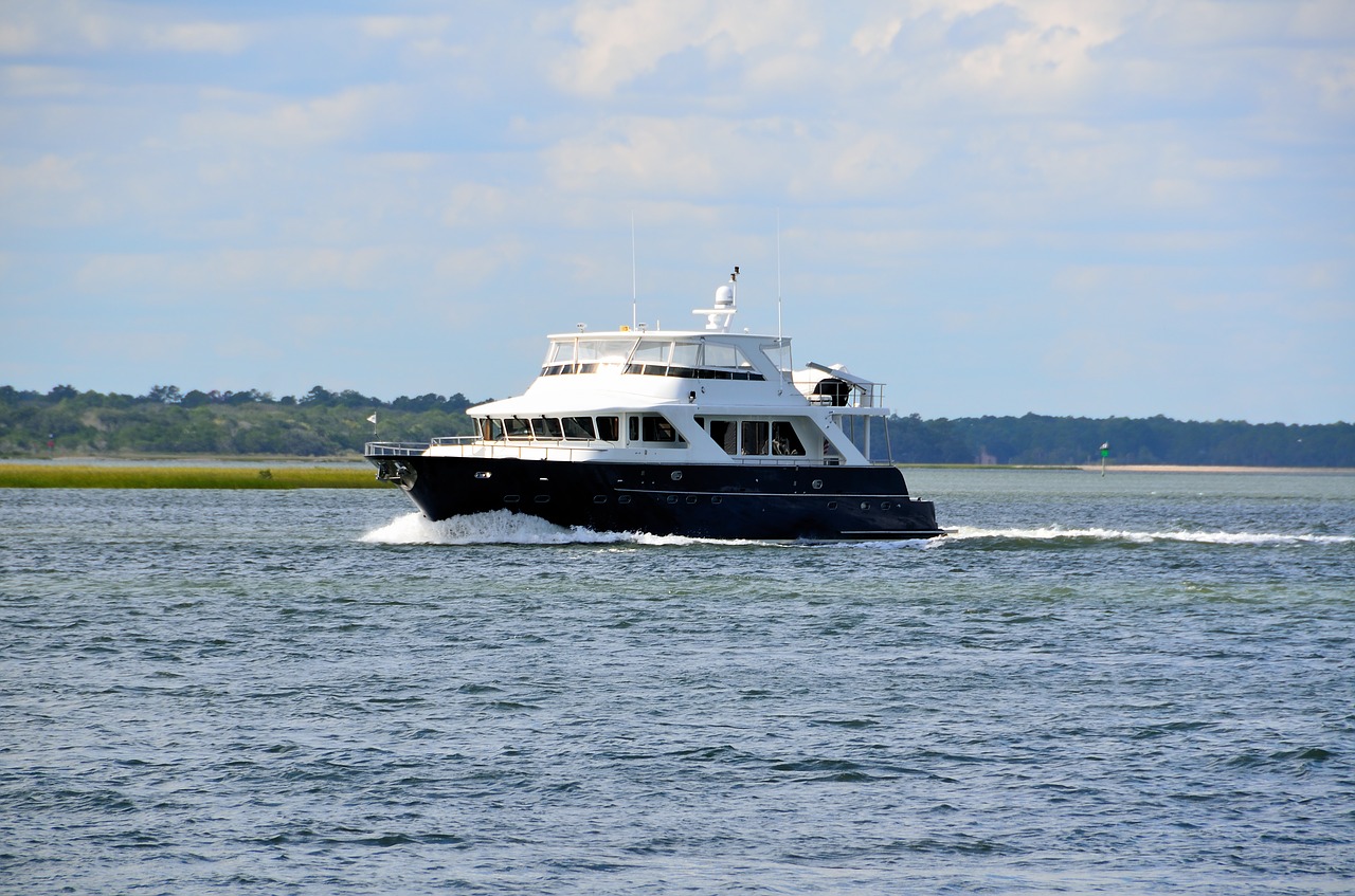 luxury yacht cruising river free photo