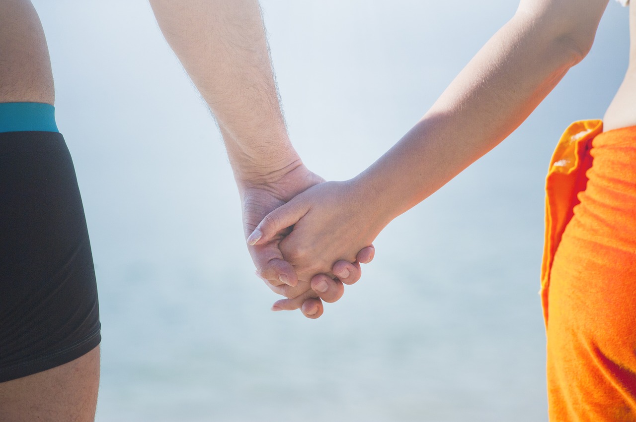 man woman holding hands free photo