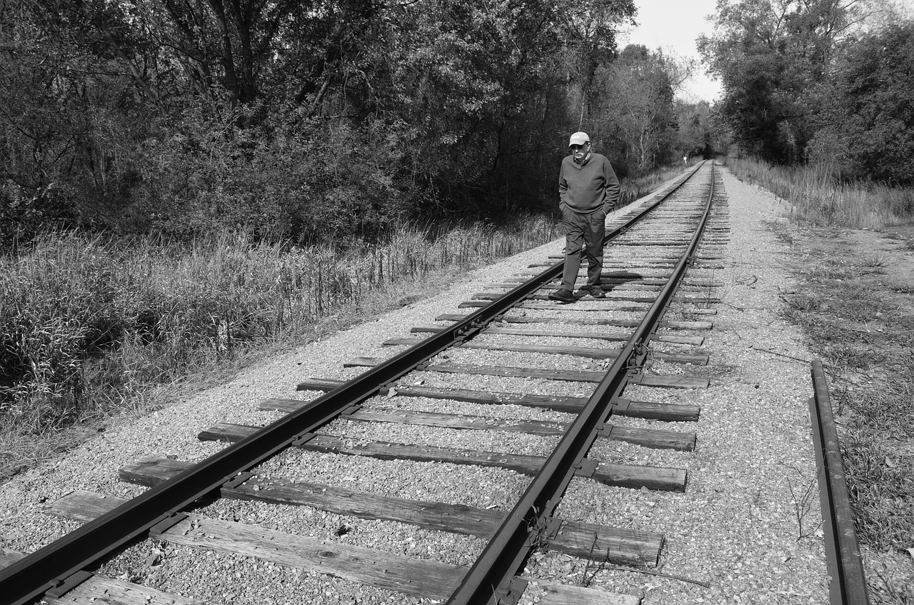 man walking railroad free photo